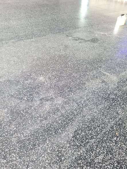 Commercial VCT vinyl tile floor before professional cleaning showing dull, dirty appearance