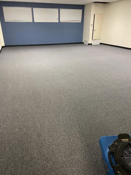 School hallway at Quinlan ISD with freshly cleaned carpet alongside trophy display corridor